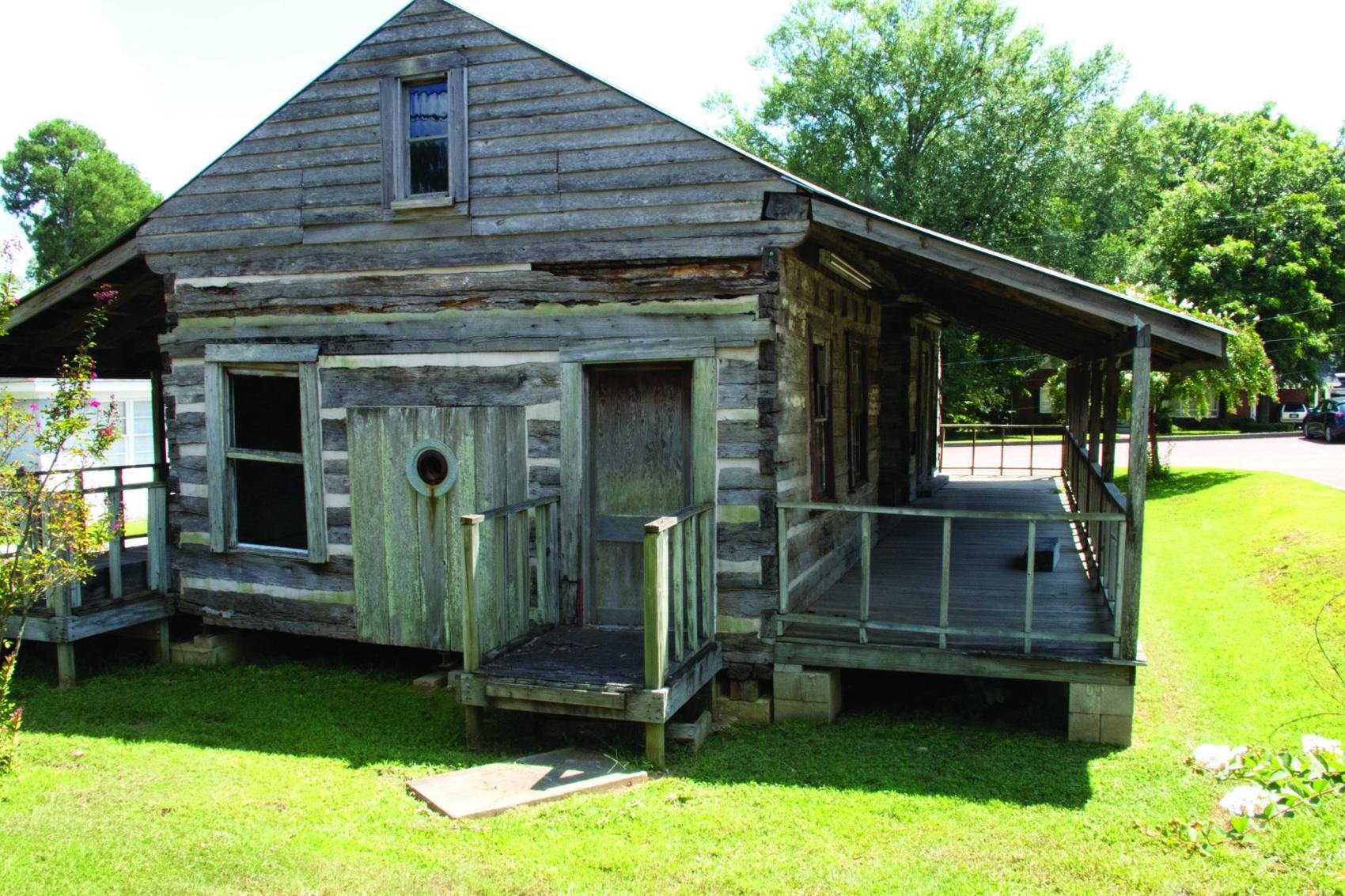 The log cabin present on the museum grounds, built in 1850