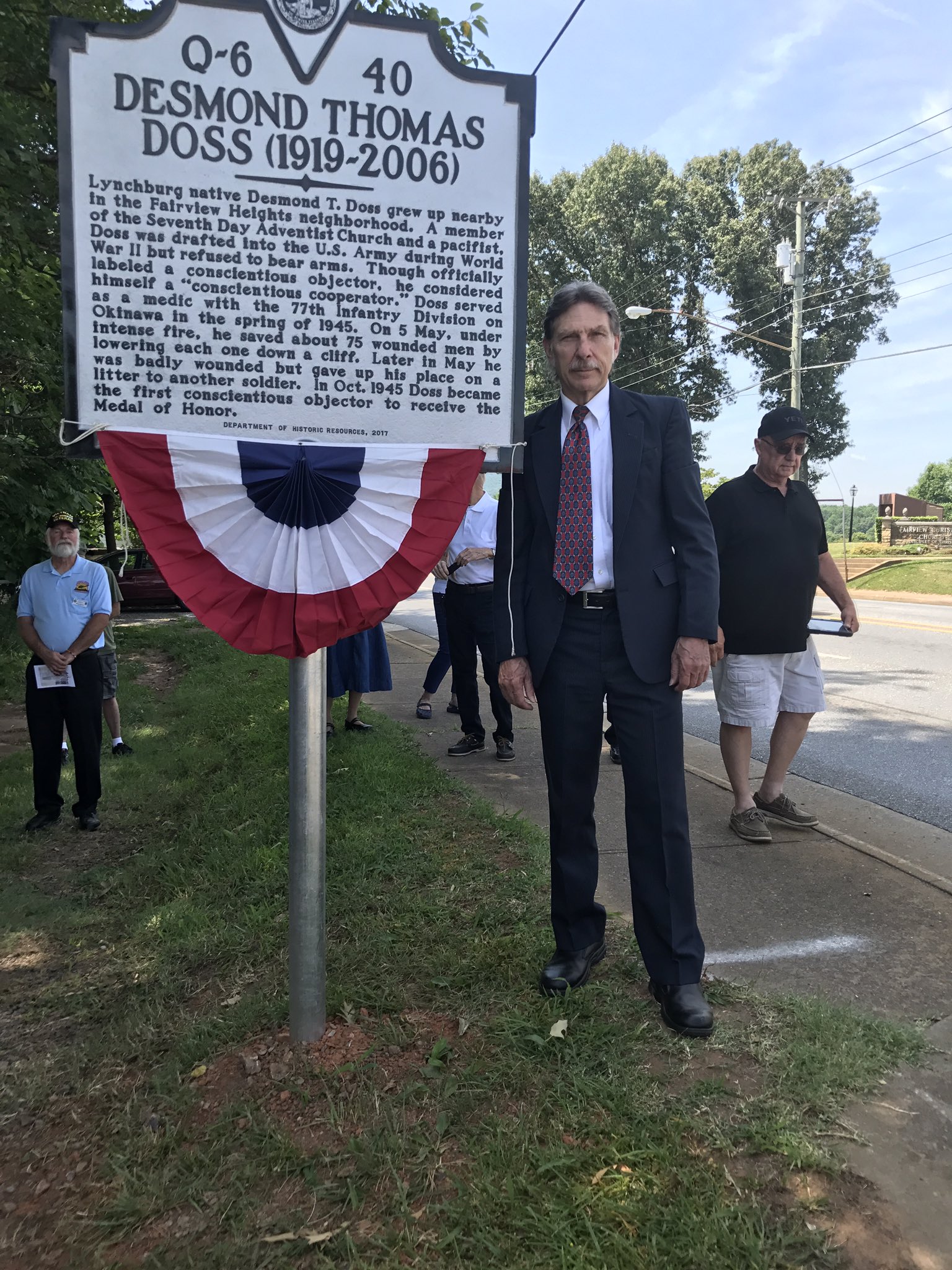Desmond Doss Jr. Standing by one of two historical markers for his father.