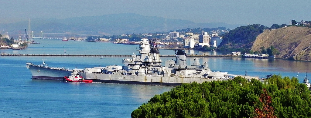USS Iowa passes former Mare Island Naval Shipyard and the city of Vallejo as it is towed to a new berth as a museum ship in Los Angeles in 2012.