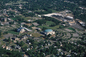 Aerial view of Temple Lot: Community of Christ temple and auditorium: largest buildings. Church of Christ's building is the small white sided one in between the former. The LDS visitors center is the rectangular one near rounded top structure.