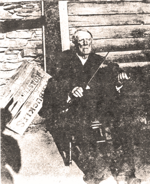 George Abner Power with his fiddle, behind his house in Land Lot 217 (Power Family Collection).