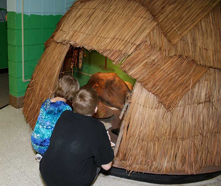 Children check out the Native American wigwam.