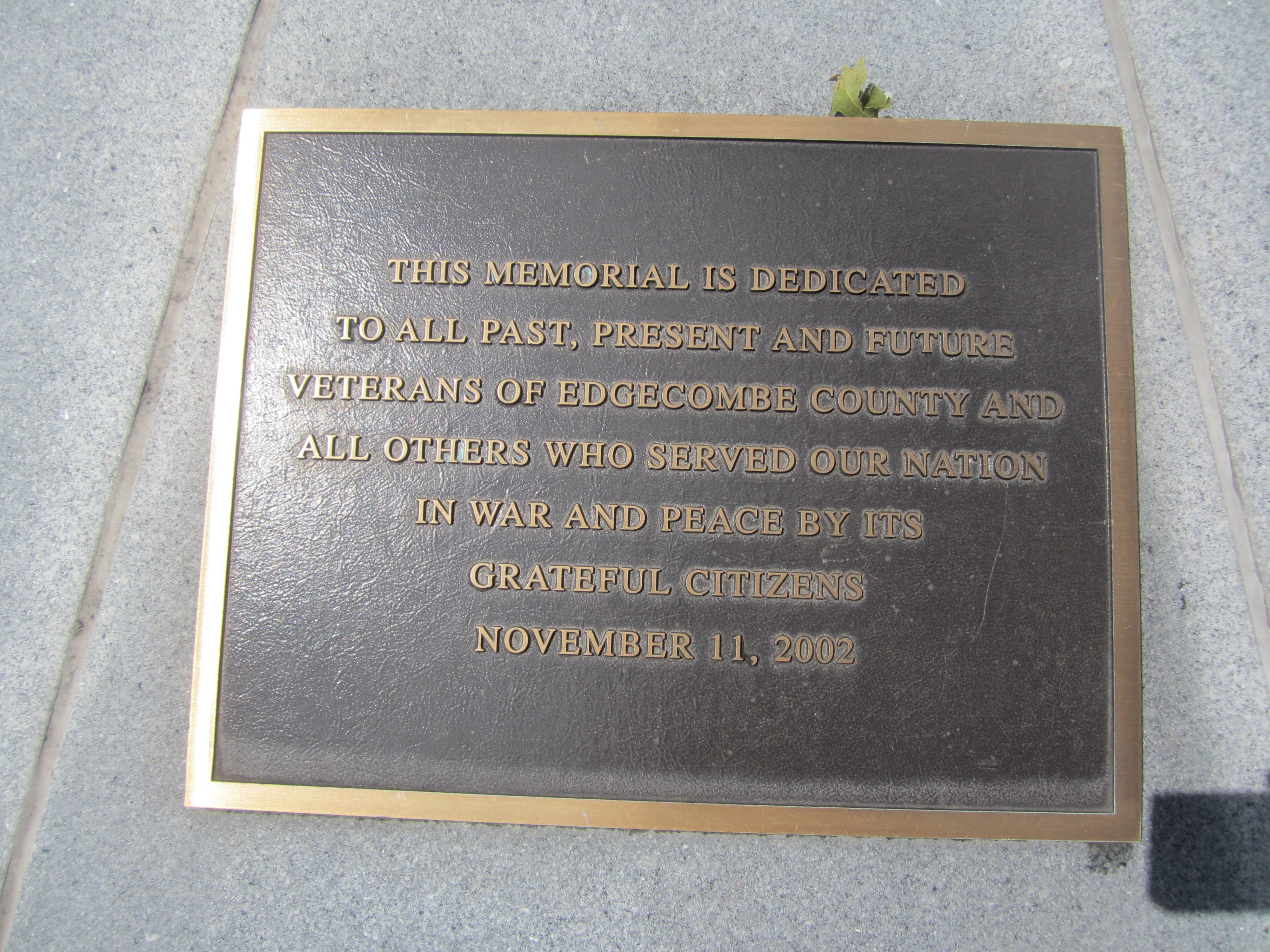 Bronze plaque of the original dedication of the Veterans Memorial