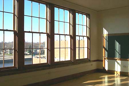 Most of the apartments in the old school still boast floor to ceiling windows, blackboards on the wall, and built-in bookcases. The hallways still have lockers!