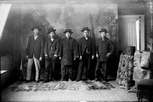 Chinese-American men pose in a photographer's studio in Georgetown, Colorado. The growth of Colorado's cities, railroads, and mines drew hundreds of Chinese workers into the state.