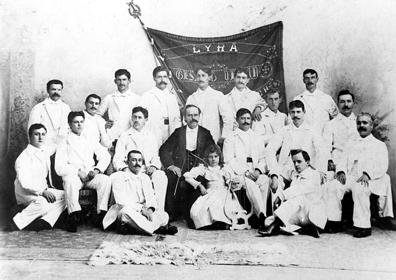 The Lyra Men's Choir, directed by Reuben Kempf with his daughter Elsa as mascot (center)