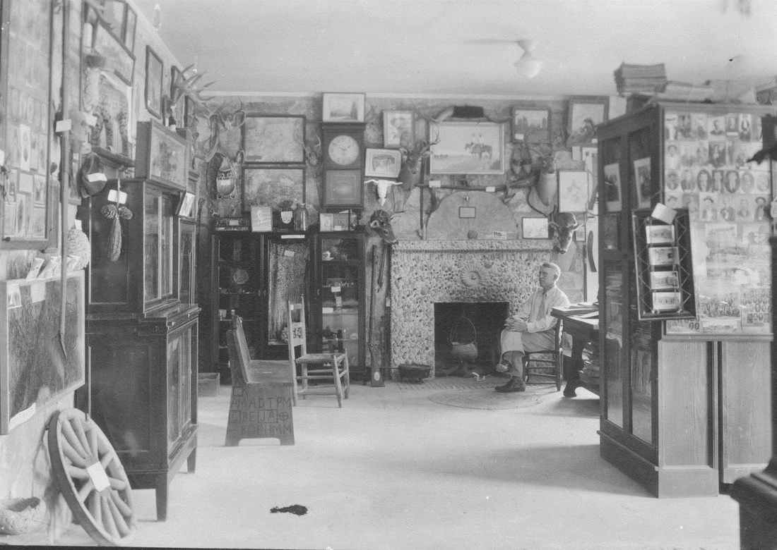 The Frontier Times Museum founder John Marvin Hunter sitting in the museum's gallery of curiosities, circa 1935.