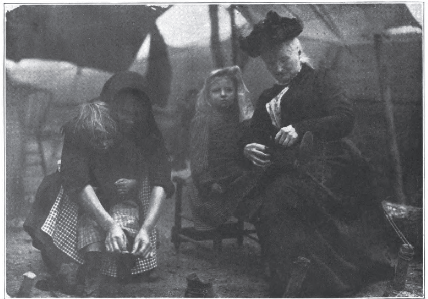 Mother Jones (far right) assisting miners' children. Jones was a prominent union organizer of her day, and a key figure in the strikes that led to the Mine Wars.