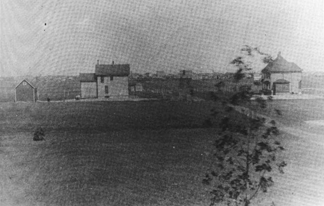 An 1888 photo of Aberdeen taken by L. Frank Baum. Main street can be seen in background. The home on the left is the Baum home.