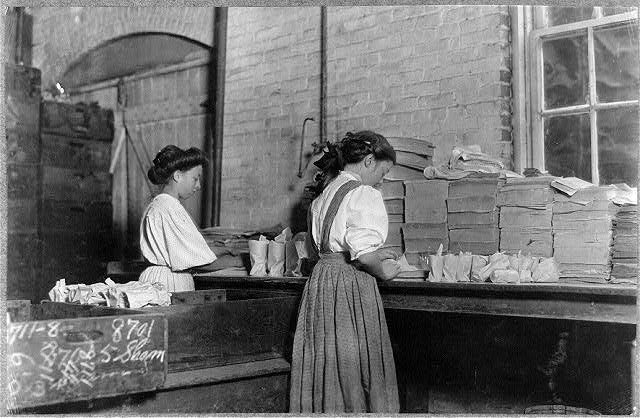 Girls at Seneca Glass wrapping and packing finished glass products. Photo by Lewis Hine, October 1908, courtesy of the Library of Congress.