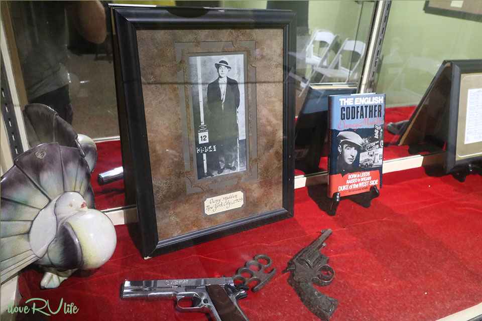 An exhibit in the Madden gallery of the museum that showcases a picture of Madden himself and some weapons.