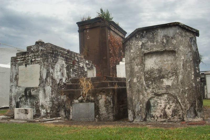 St. Louis Cemetery contains hundreds of above ground tombs and vaults, such as these.