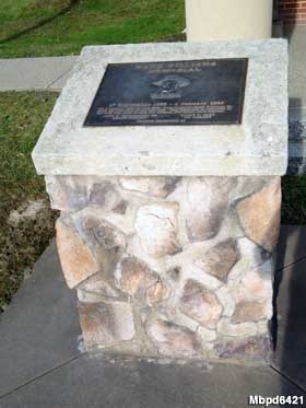 A full view of the plaque and its stone column.