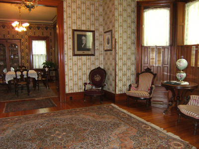 The Benton House's front parlor with a glimpse of the dining room next door.