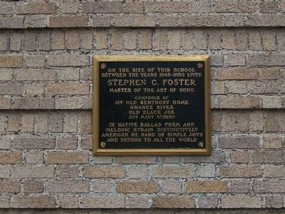 The marker is located on the Guilford Building next to the entrance.