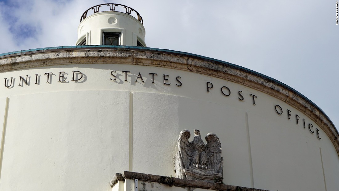 The exterior of the post office features a stone eagle and decorative cupola atop its roof.
