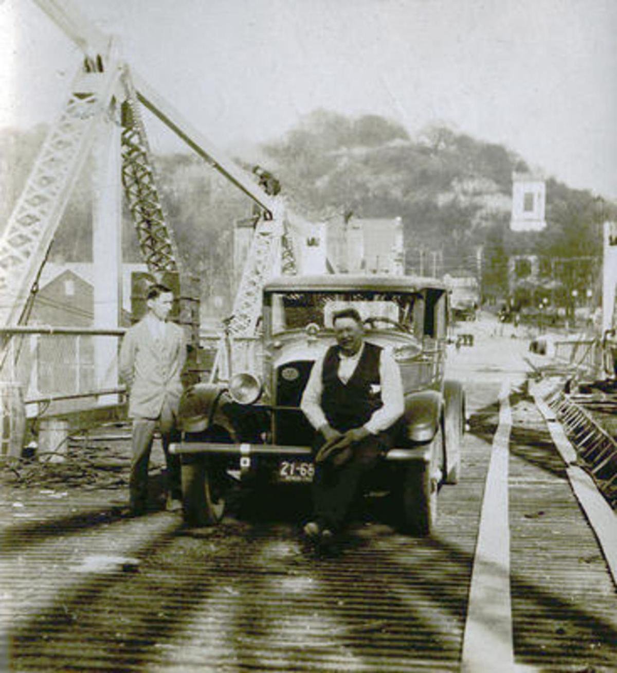 In 1928 Engineer Charles Vogel (Left) and George Cumpston (Center) were the first two people to cross the Silver Bridge in a vehicle after its construction.