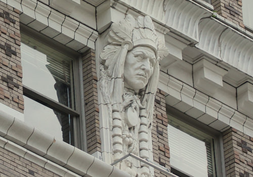 The building features Terra Cotta and ornate carvings such as this caricature of a Native American leader.