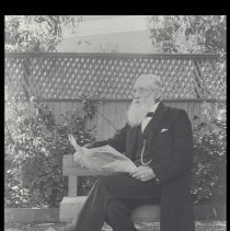 Edward Frisbie reading a newspaper