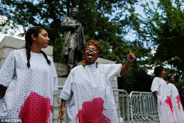 Black women from the Black Youth Project 100 protesting for the removal of the statue.