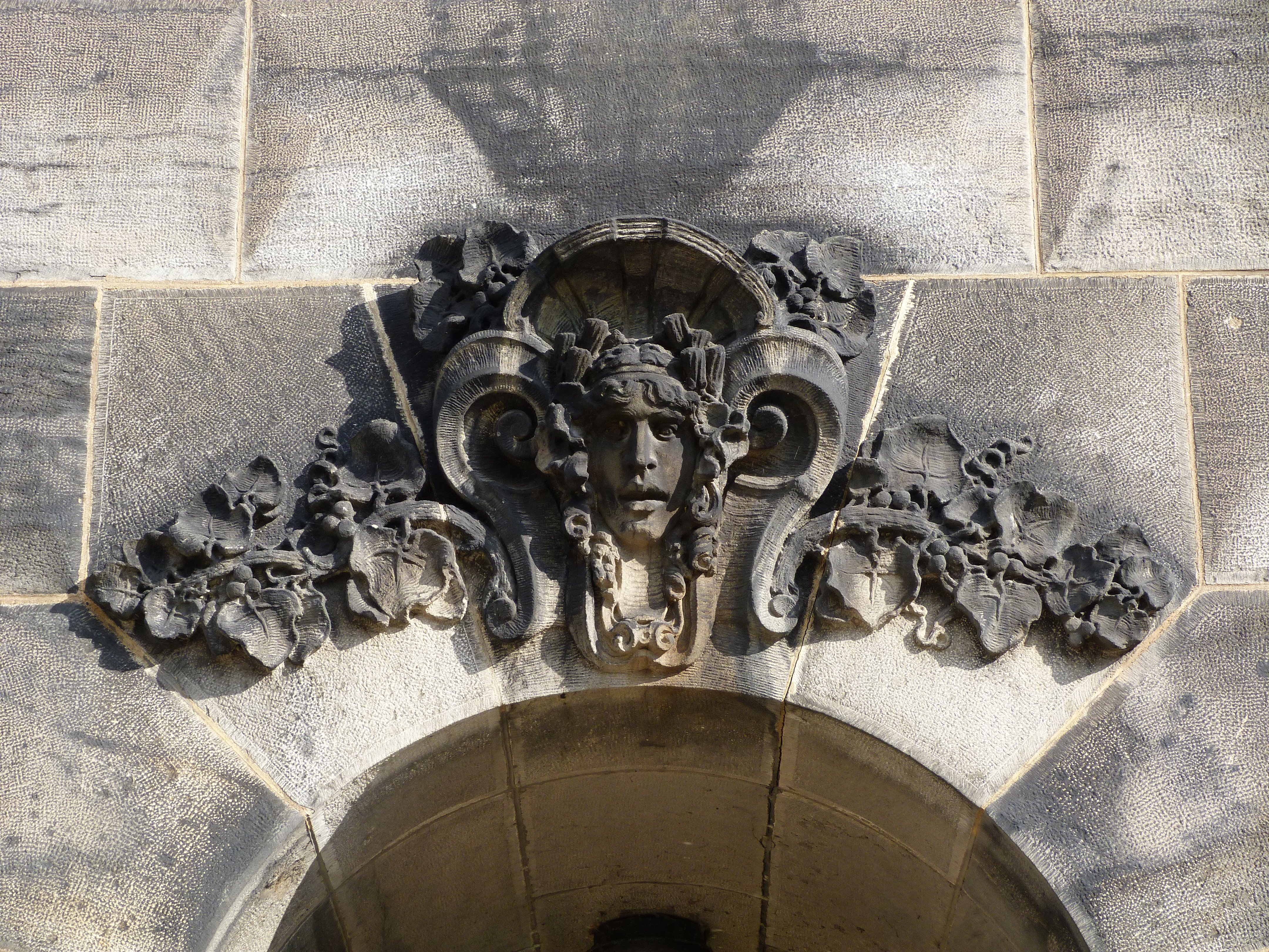 A close-up of one of the stone sculptures that resides above each of the pedestrian archways.  