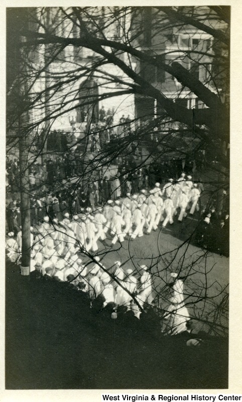 An Armistice Day parade in 1919 marching through downtown. US Navy soldiers pass 211 Willey; the white building in the far background.