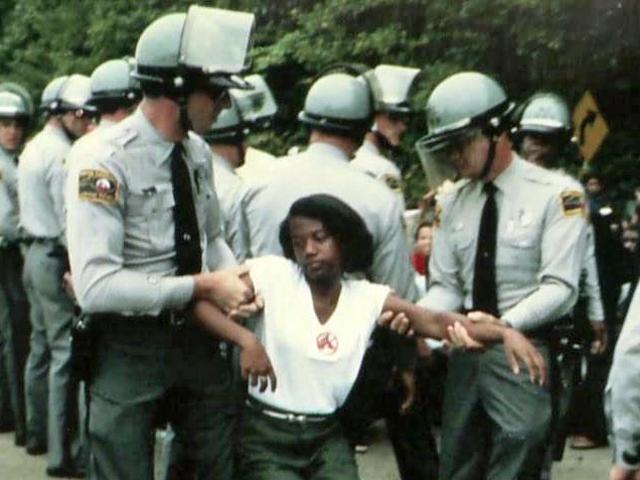 Police drag away a peaceful protestor