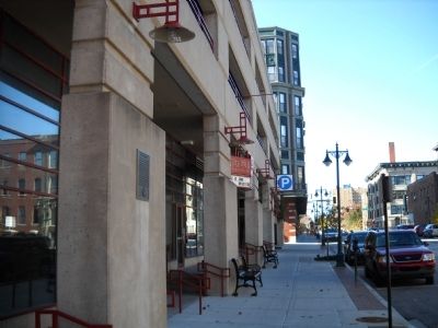 The marker is attached to the building on the left.