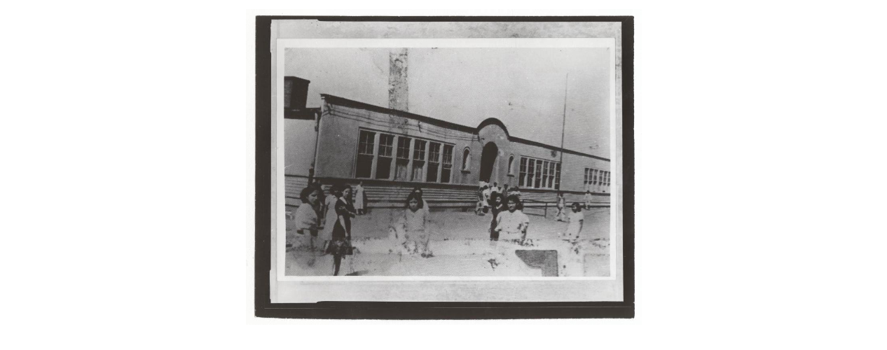 Mexican children standing outside Clara Barton. The school served the segregated Mexican community from the 1920s until the flood of 1951.