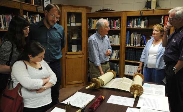 Member of the Temple of Israel overlook the Torah.