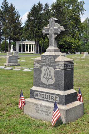 Peter J. McGuire gravesite with Memorial in background