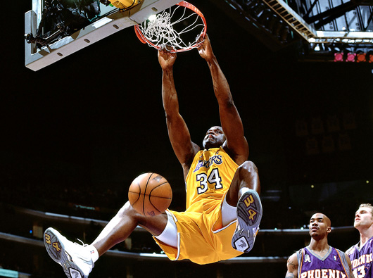 Shaquille O'Neal preforming one of his signature two handed slams.