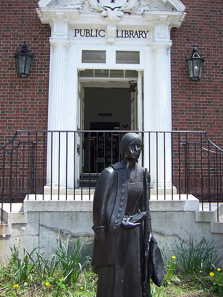 The statue stands in front of the Sharon Public Library (History of Massachusetts)