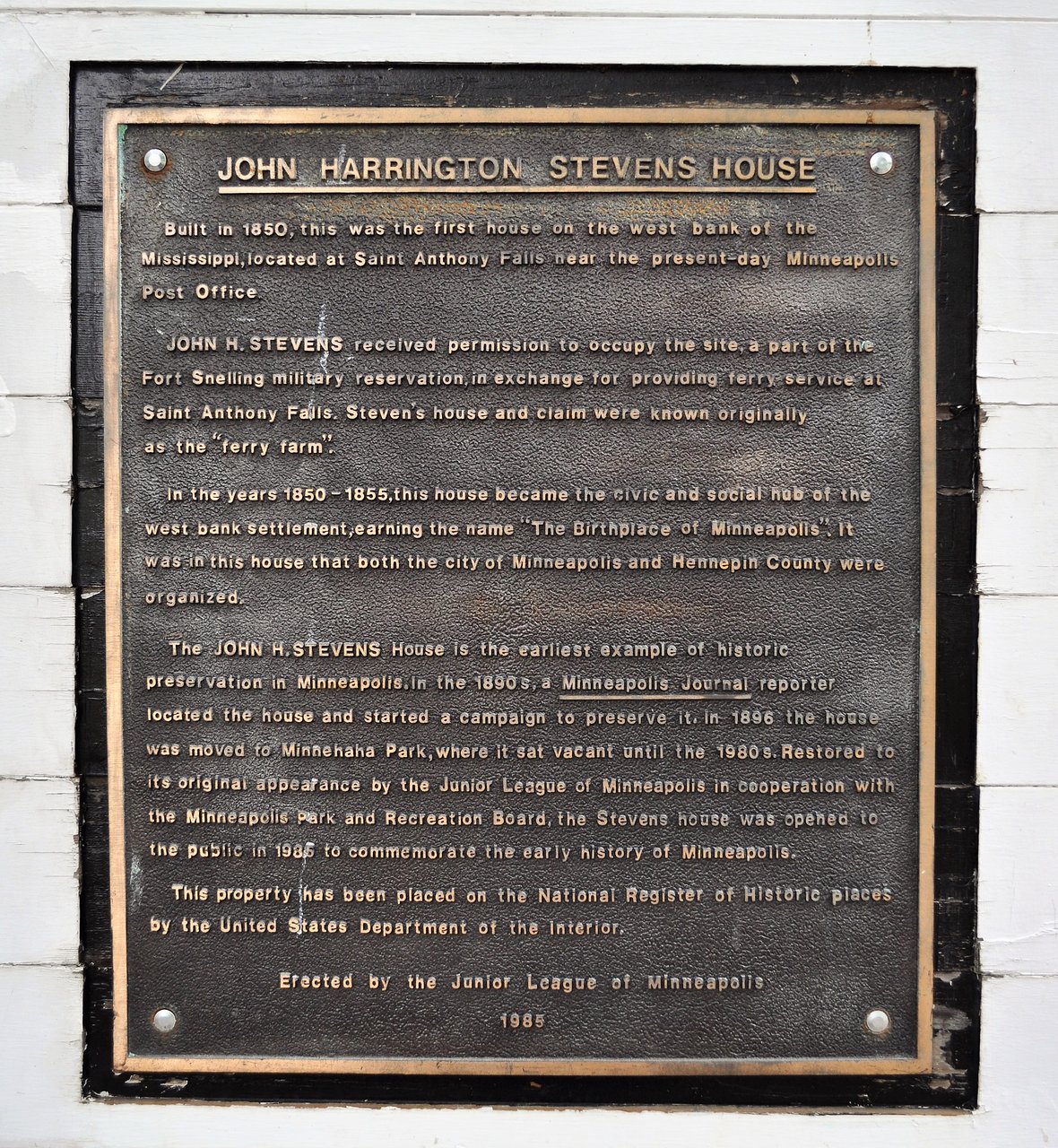 A plaque detailing the history of the house and its preservation