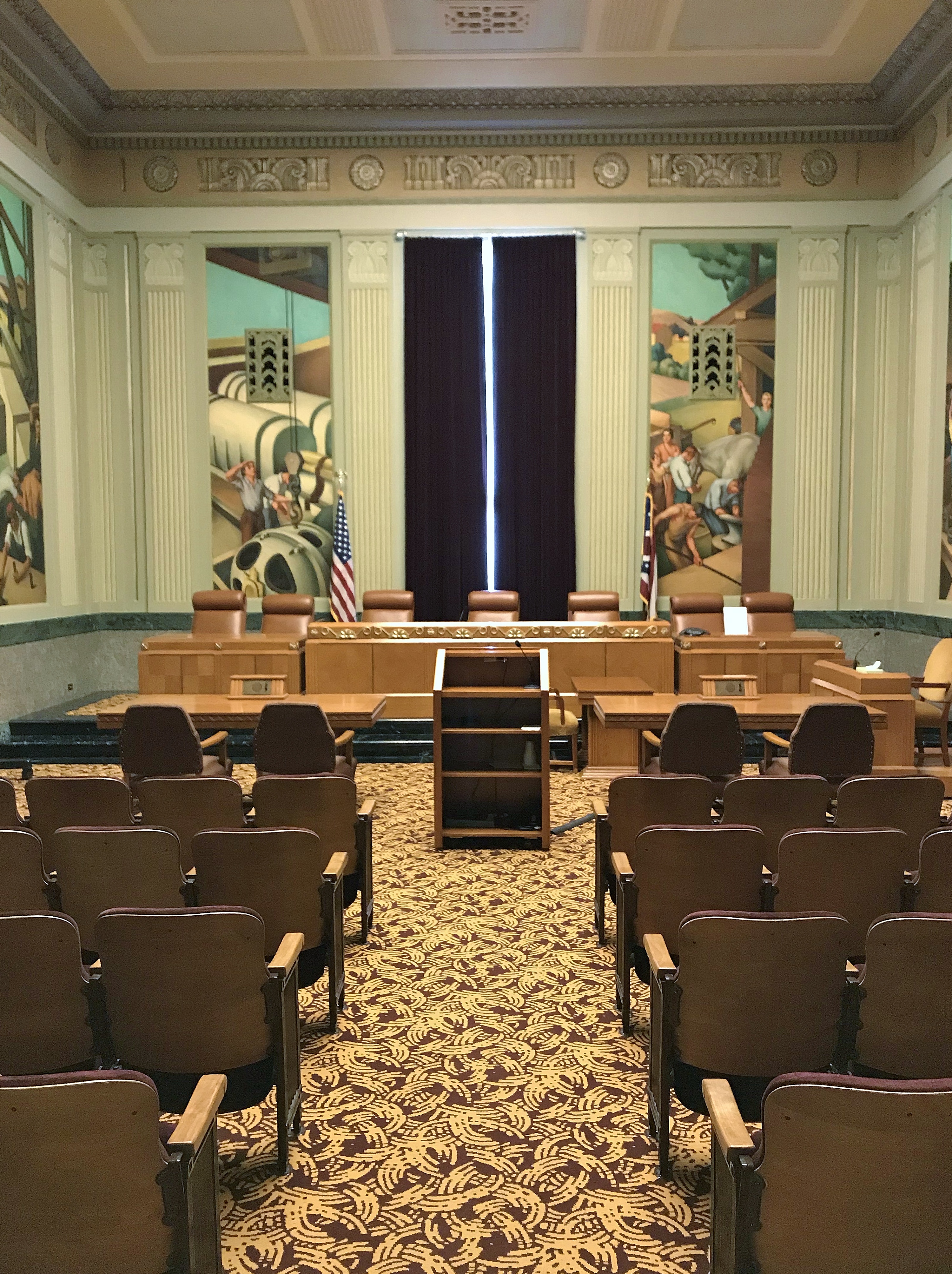 The north hearing room was originally used by the Industrial Commission to hold workers' compensation hearings, but today it is primarily used by the Board of Professional Conduct for hearings. The original murals were painted by Cincinnati artist John Holmer.