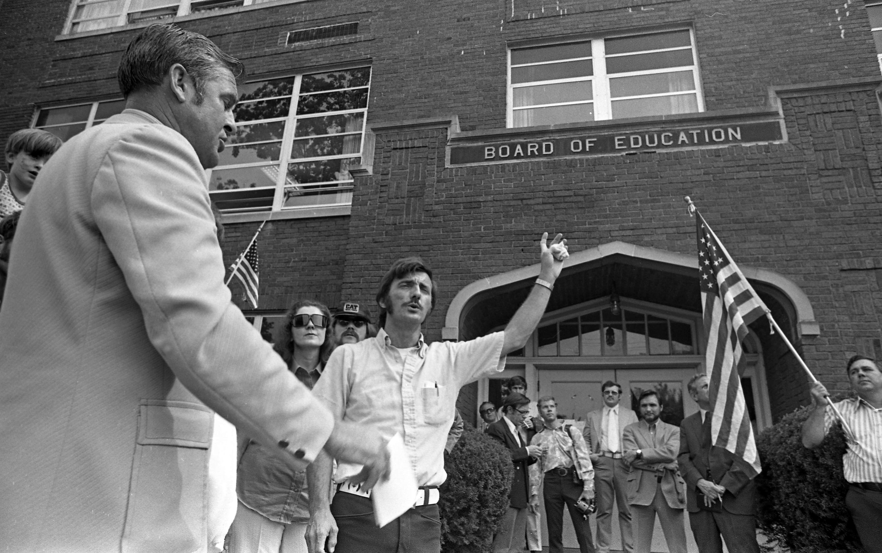 Reverend Avis Hill leads a Sept. 18, 1974 anti-textbook rally outside the Board of Education building in Charleston.  A month later, a bomb exploded under the building's gas meter shortly after a School Board meeting adjourned.