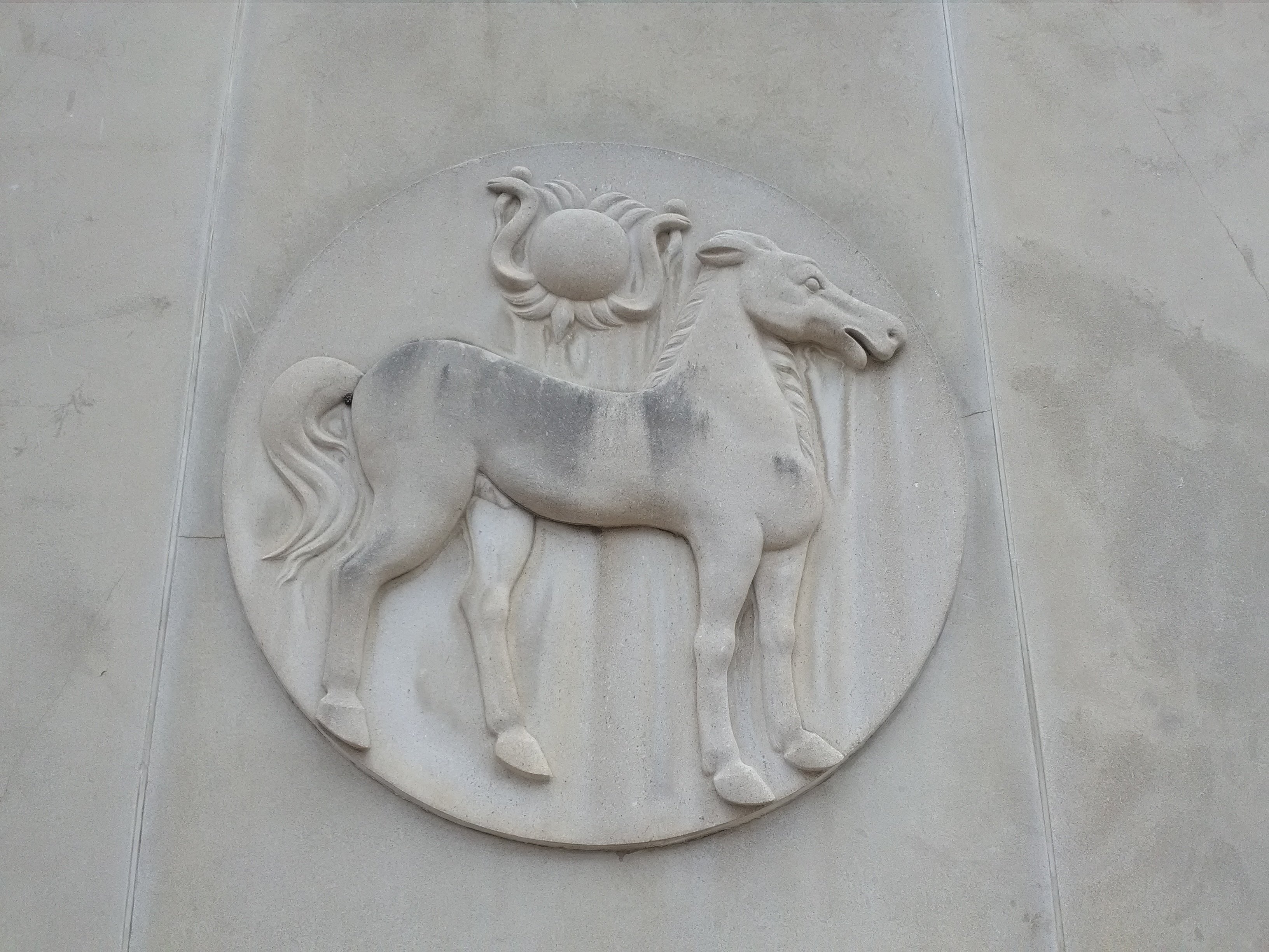 One of several stone sculptures on the West Fourth Street side of the former Bank of Carthage building.