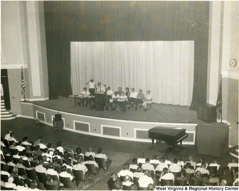 Group seated on the stage of the Morgantown High School auditorium before an audience. Date unknown. Courtesy of the West Virginia and Regional History Center.