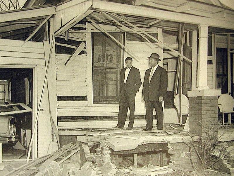 Abernathy (right) photographed surveying the damage to his home following a bombing by members of the Ku Klux Klan. Image from From New Georgia Encyclopedia. 