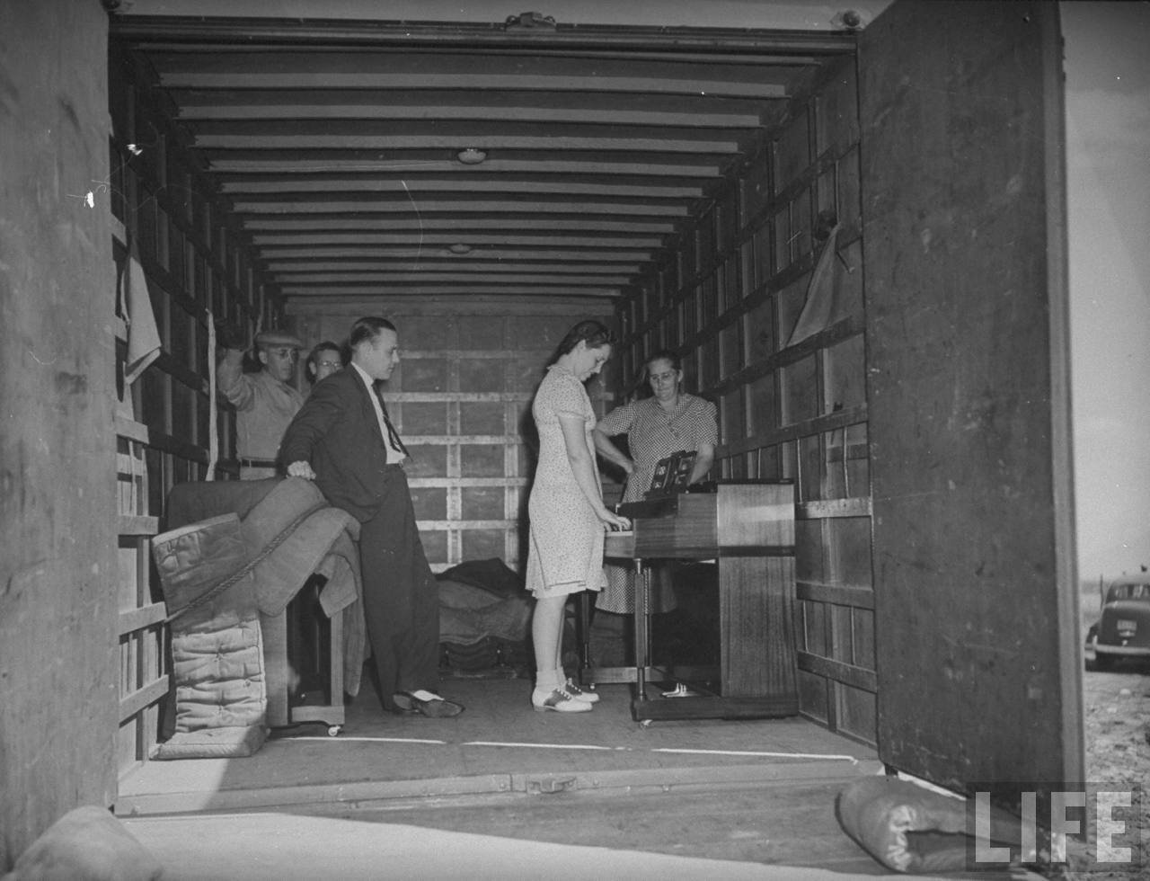 Midwest farm woman testing Jenkins Music Company piano (from 1940 Life Magazine article)