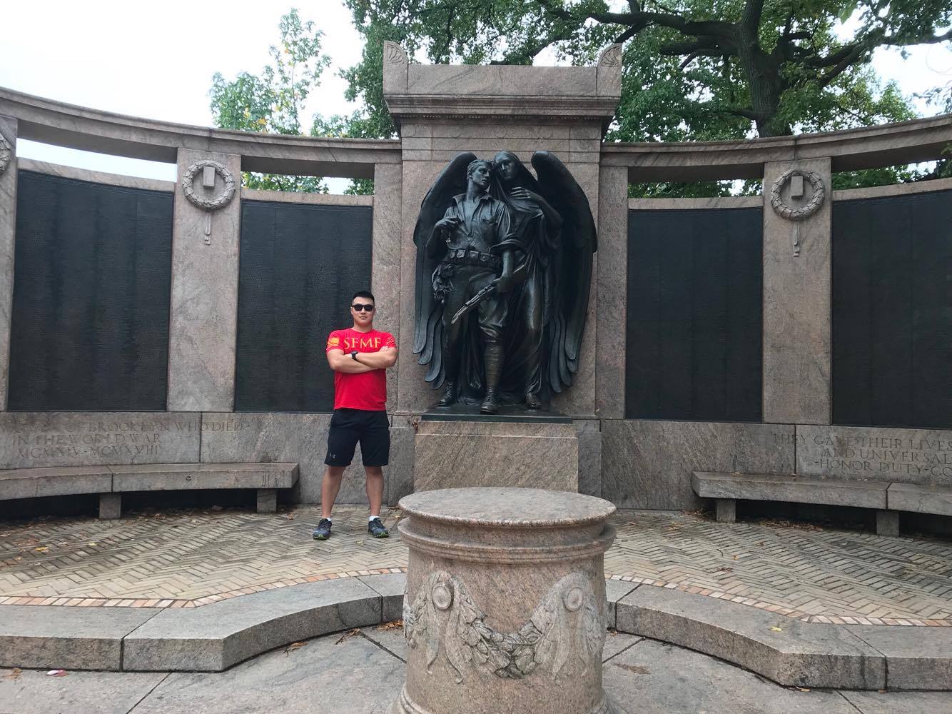 NYU student and the original author of this entry stands with the monument.