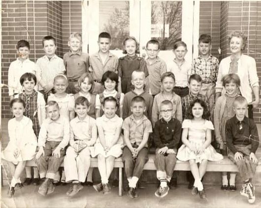 Class photo outside Ensign Elementary, circa 1960s