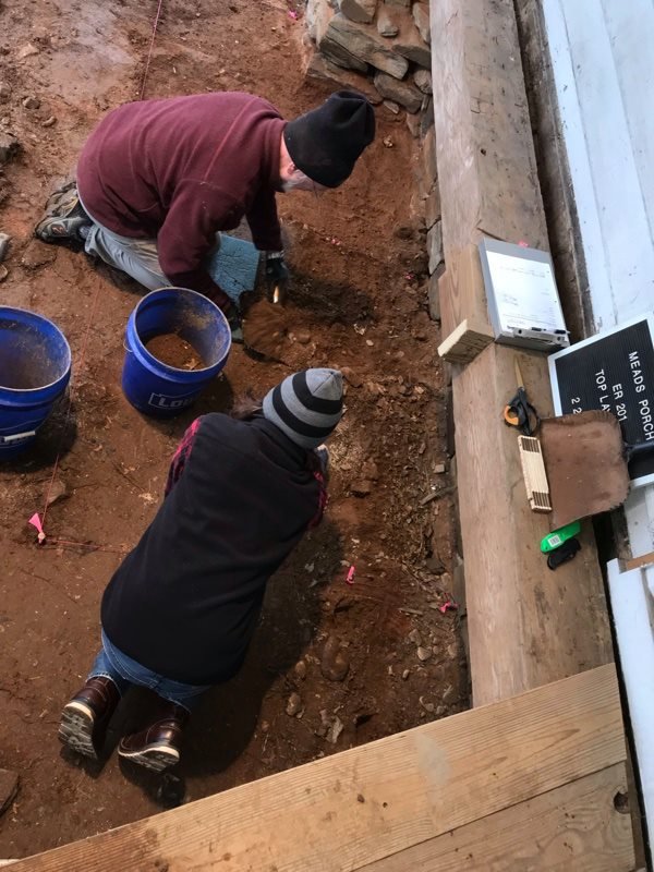 Liberty University archaeologist and student working on an excavation underneath the porch at Mead's Tavern.
