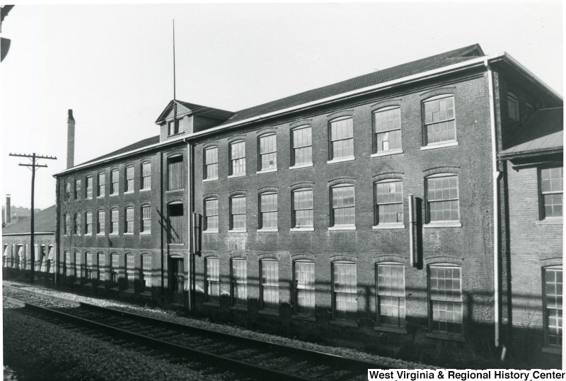 The original brick mill that later served as part of a glass factory complex. It was demolished in 1998. Photo courtesy of the West Virginia and Regional History Center, WVU Libraries.
