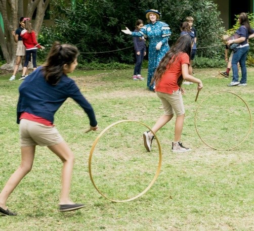 School children playing with hoops on a field trip (2000s)