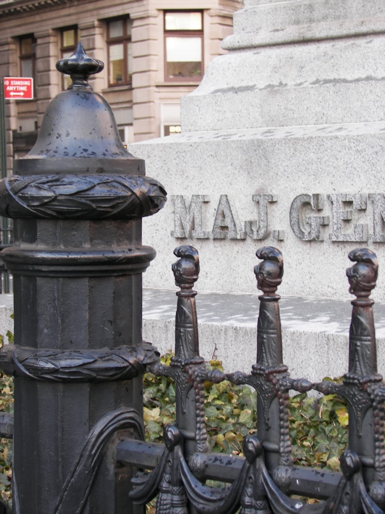A close-up of the ornamental fence (with replica Congressional Sword of Honor pickets) surrounding the monument