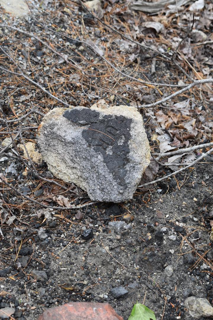 Rock near the power lines with numbers on it.
