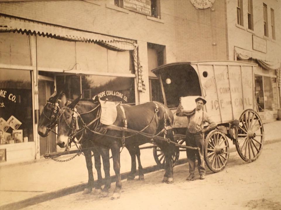 Prior to opening the Cobbler Shop and Confectionery in 1920, the buildings were used by the Mount Hope Coal and Coke Company. Viewed in the front of the building is an ice delivery service.