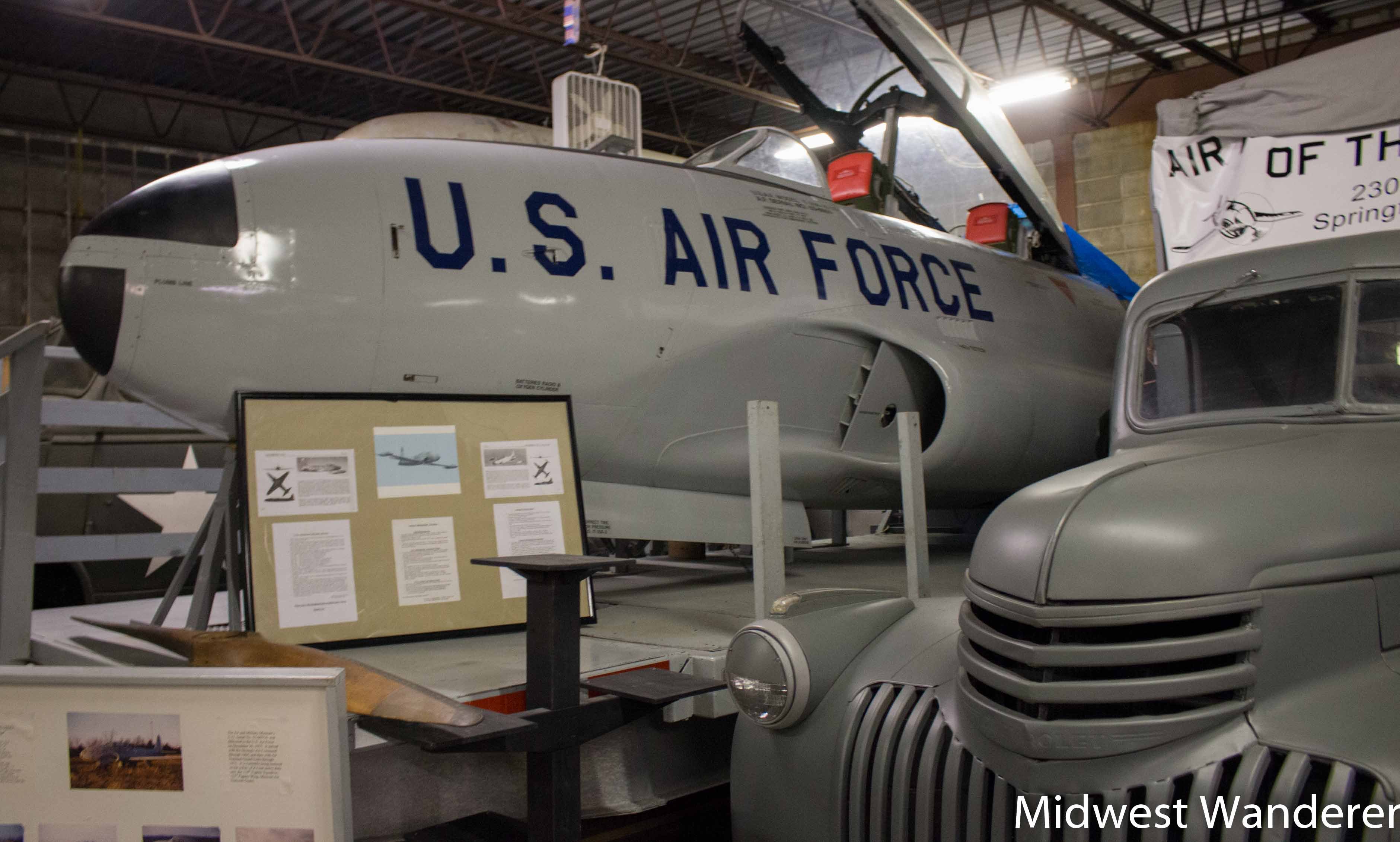 Midwest Wanderer and the cockpit of an F-80 fighter jet on display in the museum.