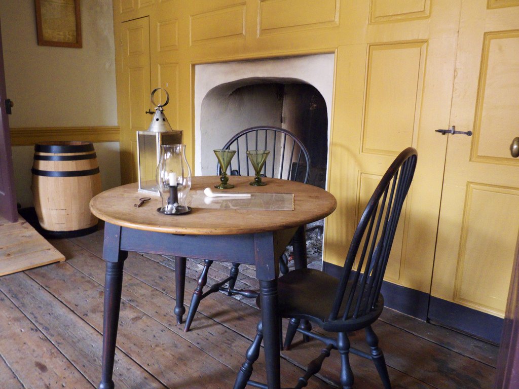 A small table placed in front of one of five fireplaces within the Bachmann House.